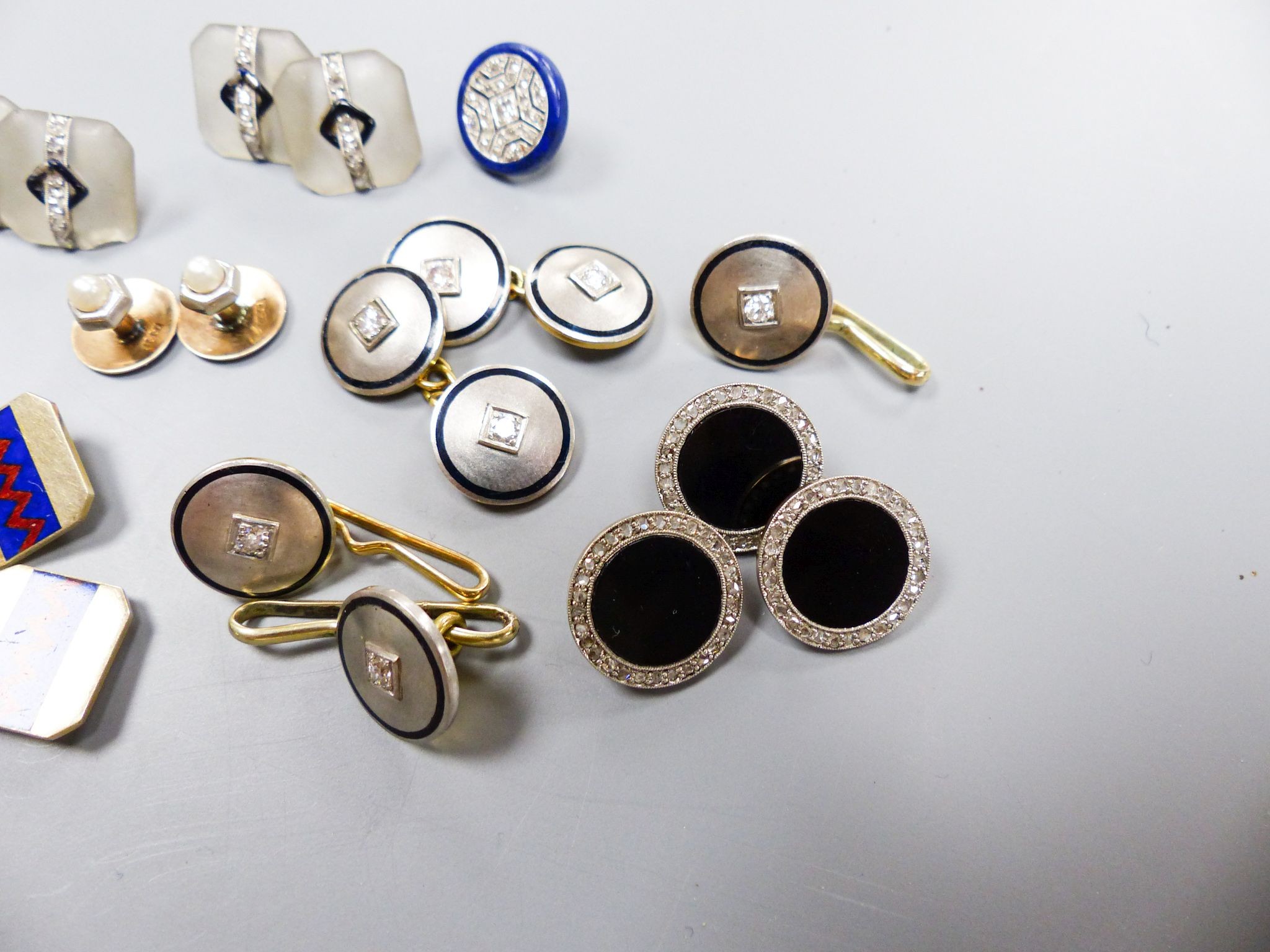 A pair of yellow and white metal, diamond and black enamel cufflinks and three similar dress studs, 11mm, one stamped 14k, gross 21.9 grams, four frosted glass, black enamel and diamond set dress studs(a.f.), two 15ct &